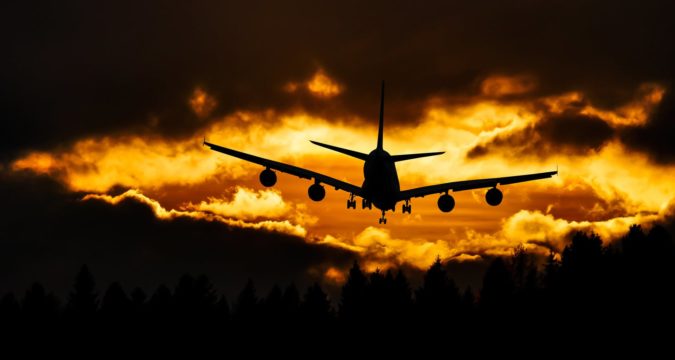 airplane silhouette on air during sunset