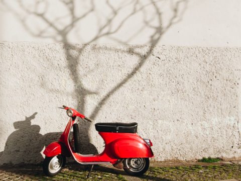 red motor scooter near wall