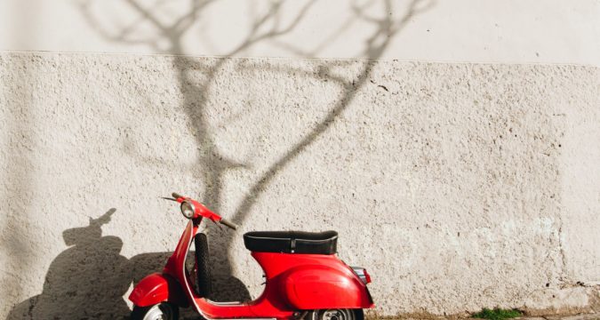 red motor scooter near wall